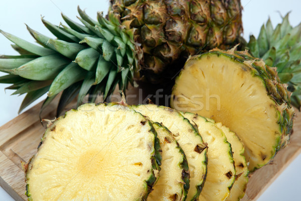 Slices of pineapples on a cutting board still life Stock photo © mizar_21984