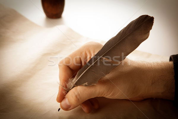 writer holds a fountain pen over writing paper and a signature Stock photo © mizar_21984