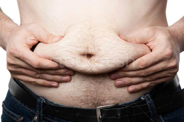 a man feels his fat on his paunch Stock photo © mizar_21984