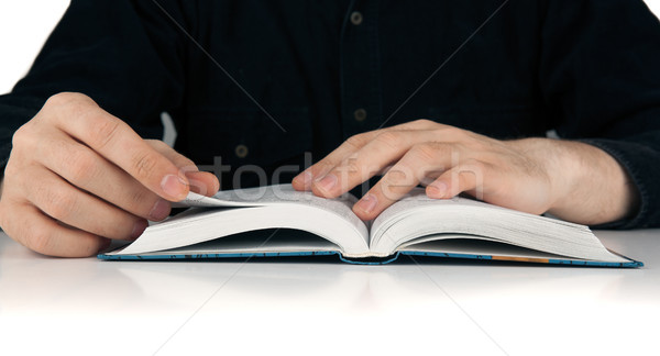 Man's hands and man looking for something in the book Stock photo © mizar_21984