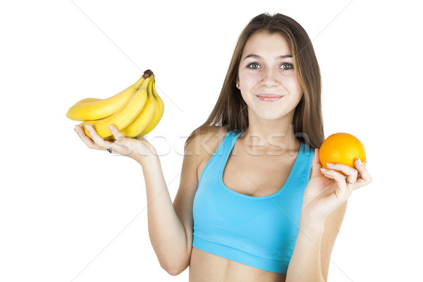 Athletic girl holding fruit Stock photo © mizar_21984
