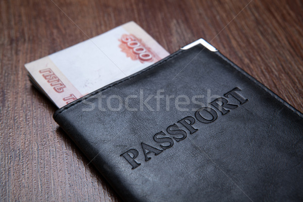 Passport on a table with paper money Stock photo © mizar_21984