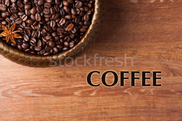 Stock photo: roasted coffee beans in a bamboo basket with title