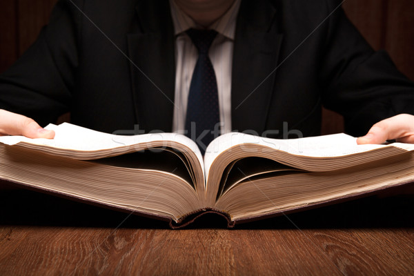 Homme regarder informations dictionnaire livre Photo stock © mizar_21984