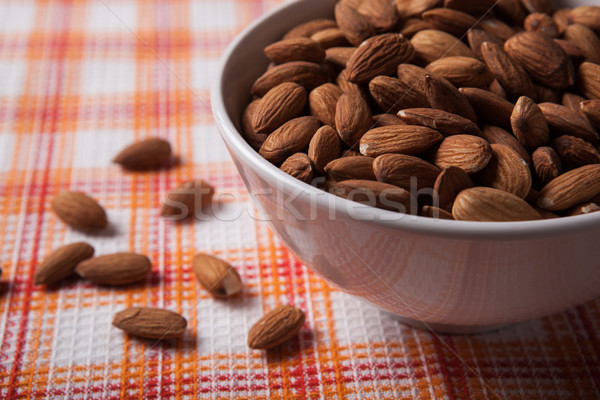 large grains of almonds in the shell and the bowl Stock photo © mizar_21984