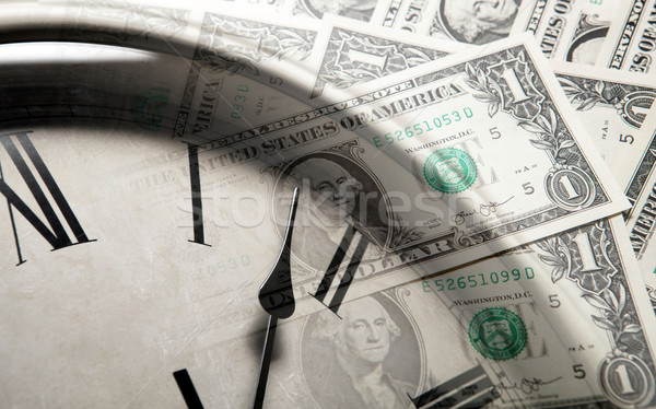 clock on the background of banknotes dollars Stock photo © mizar_21984