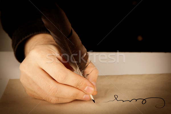 writer holds a fountain pen over writing paper and a signature Stock photo © mizar_21984