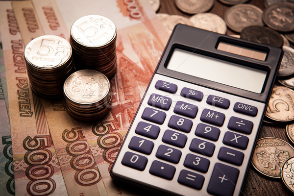 Stock photo: handful of Russian rubles with calculator