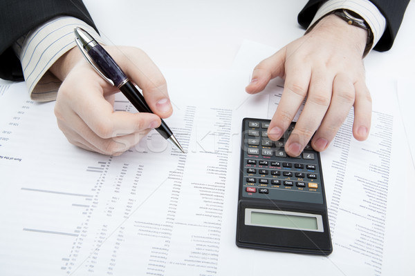 businessman holding a pen and counts the budget Stock photo © mizar_21984