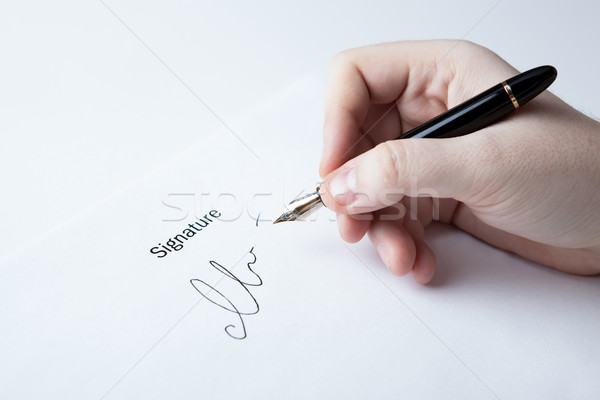 pen in the man's hand and signature Stock photo © mizar_21984