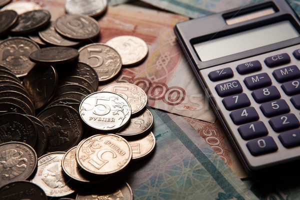 Stock photo: handful of Russian rubles with calculator