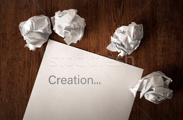 Stock photo: still life of paper and a crumpled paper on a table with an insc