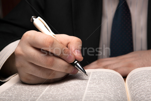 man is looking for information in the dictionary Stock photo © mizar_21984