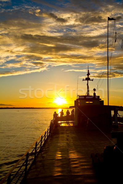 Stock photo: Some friends ejoy the last light on the Amazon river.