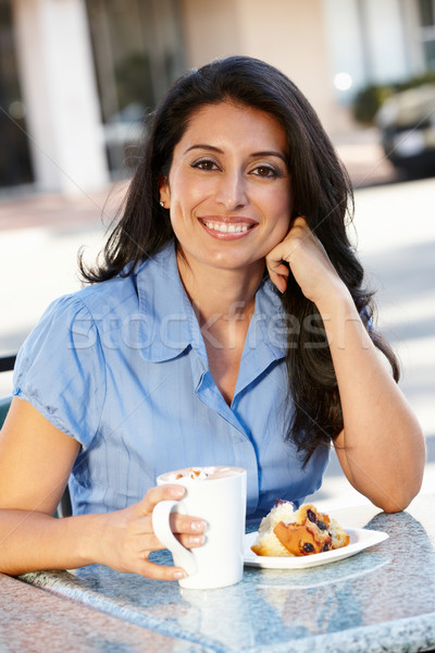 Hispanic woman sitting at sidewalk caf Stock photo © monkey_business