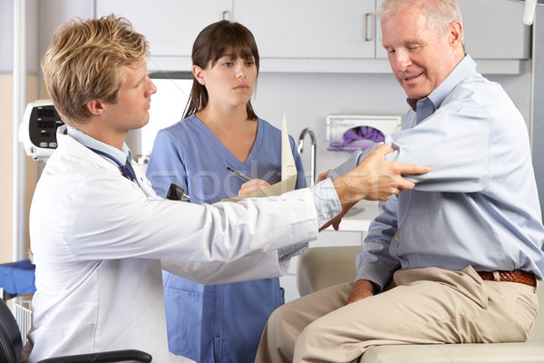 Doctor Examining Male Patient With Elbow Pain Stock photo © monkey_business