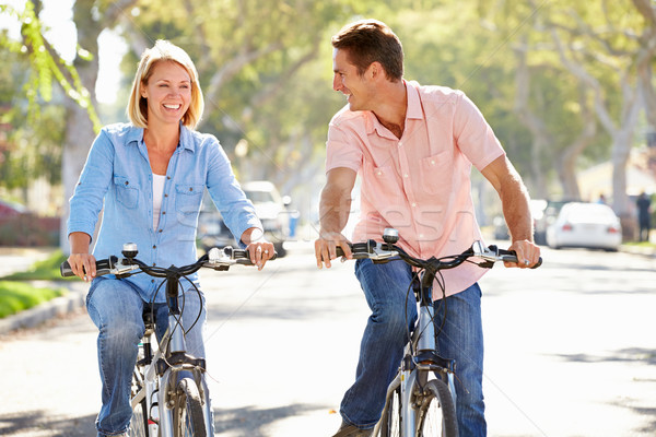 Pareja ciclismo suburbano calle carretera mujeres Foto stock © monkey_business