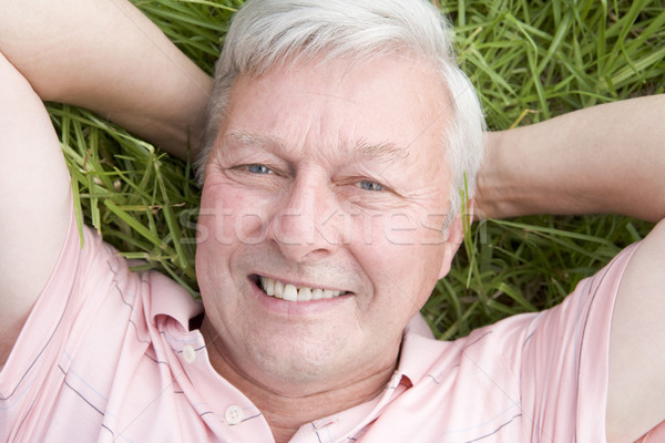 Man lying in grass smiling Stock photo © monkey_business
