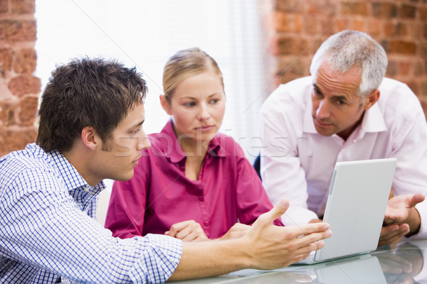 Three businesspeople in office with laptop Stock photo © monkey_business