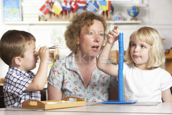 Adult Helping Two Young Children at Montessori/Pre-School Stock photo © monkey_business