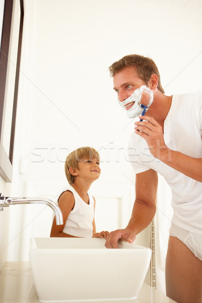 Stock photo: Son Watching Father Shaving In Bathroom Mirror