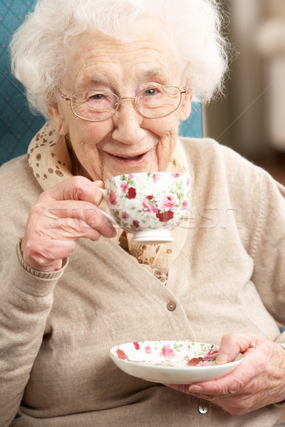 Starszy kobieta kubek herbaty domu Zdjęcia stock © monkey_business