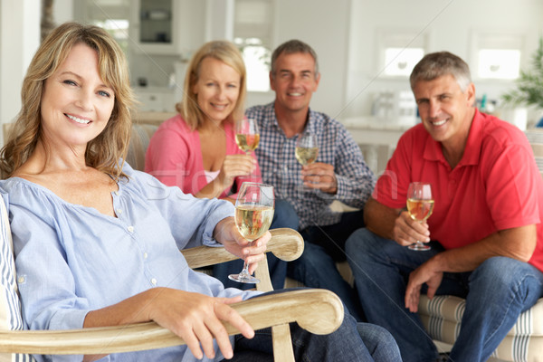 Mid age couples drinking together at home Stock photo © monkey_business