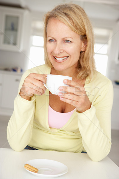Mid age woman with coffee at home Stock photo © monkey_business
