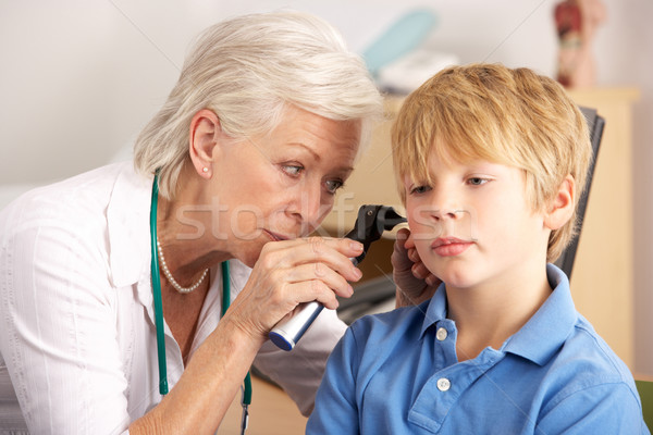 British GP examining young boy's ear Stock photo © monkey_business
