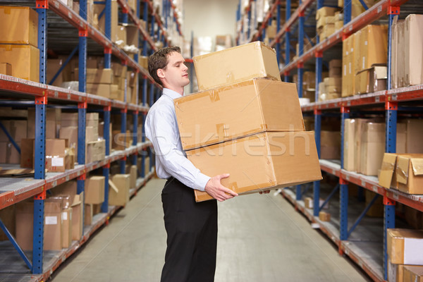 Man Carrying Boxes In Warehouse Stock photo © monkey_business