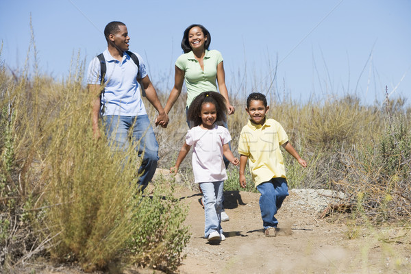Family walking on path holding hands and smiling Stock photo © monkey_business