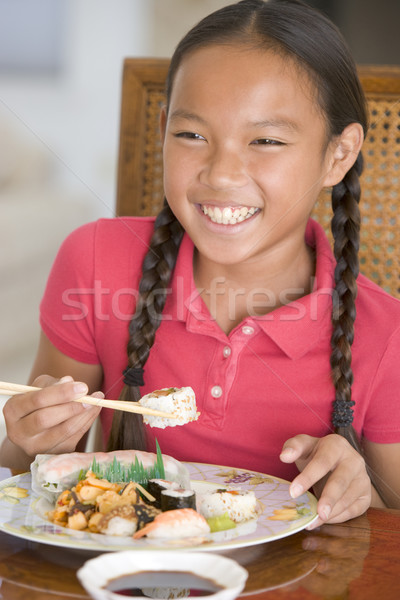 Young girl in dining room eating Chinese food smiling Stock photo © monkey_business