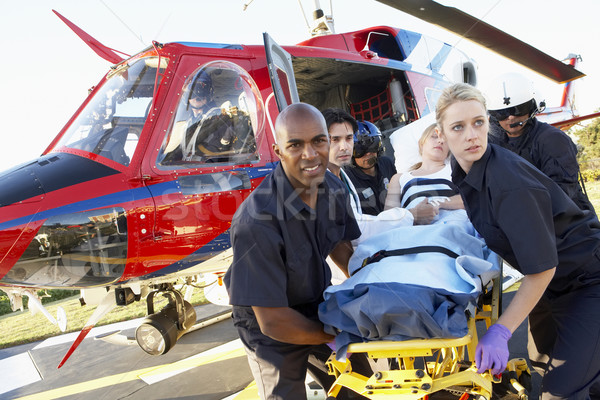 Stock photo: Paramedics unloading patient from Medevac