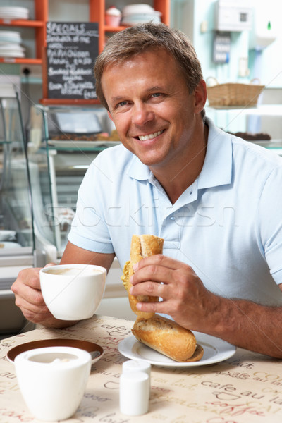 Male Customer Enjoying Sandwich And Coffee In Caf Stock photo © monkey_business