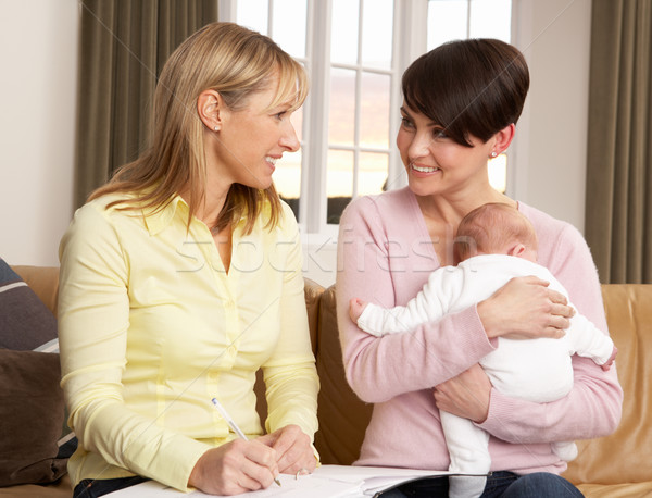 Stock photo: Mother With Newborn Baby Talking With Health Visitor At Home