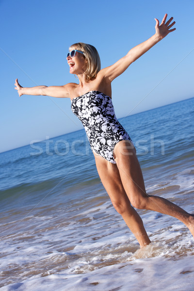 Senior Woman Enjoying Beach Holiday Stock photo © monkey_business
