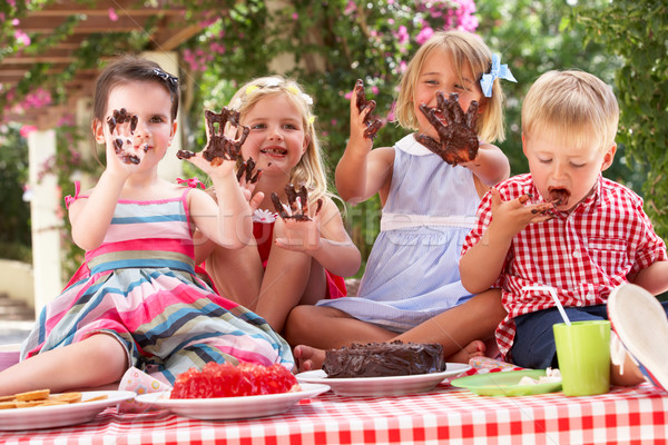 Group Of Children Eating Jelly And Cake At Outdoor Tea Party Stock photo © monkey_business