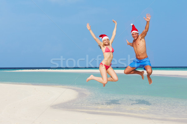 Couple sautant plage [[stock_photo]] © monkey_business