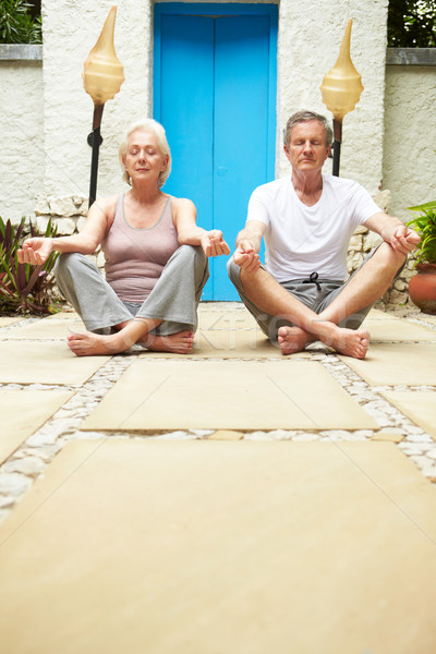 Senior Couple Meditating Outdoors At Health Spa Stock photo © monkey_business