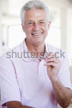 Homem vitória loteria bilhete animado sorridente Foto stock © monkey_business