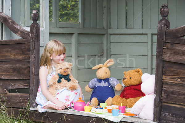 Young girl in shed playing tea and smiling Stock photo © monkey_business