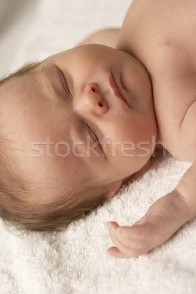 Stock photo: Close Up Of Baby Sleeping On Towel