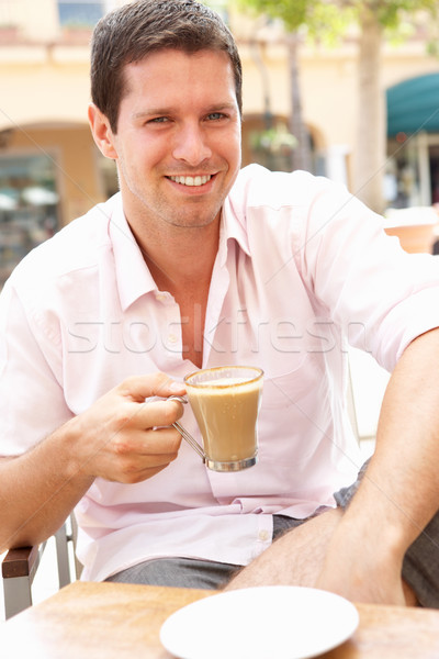 Young Man Enjoying Cup Of Coffee In Caf Stock photo © monkey_business