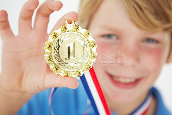 Young boy showing off medal Stock photo © monkey_business