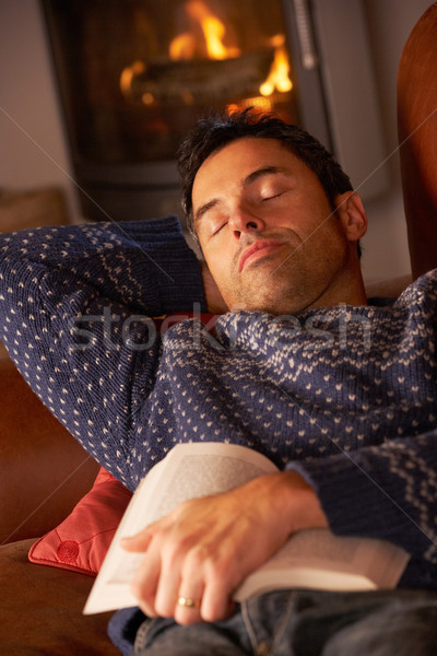 Middle Aged Man Asleep With Book By Cosy Log Fire Stock photo © monkey_business