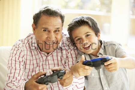Man and young boy with handheld game smiling Stock photo © monkey_business