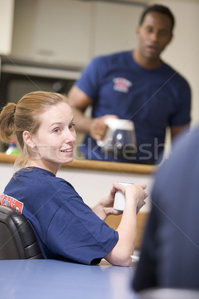 Firefighters relaxing in the staff kitchen Stock photo © monkey_business