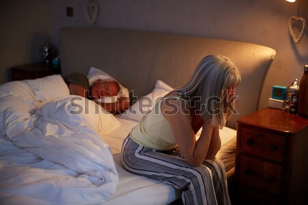 A young woman lying on her couch eating chocolate Stock photo © monkey_business