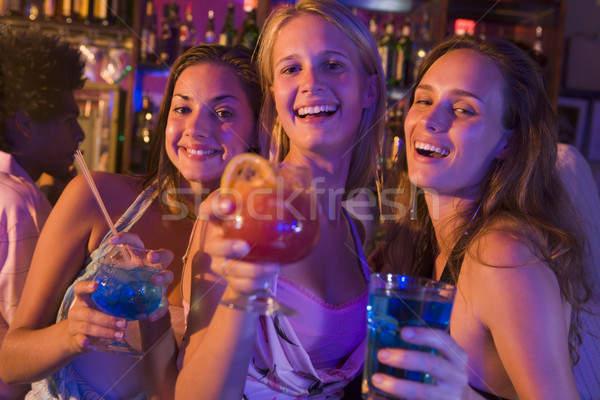 Three young women with drinks in a nightclub Stock photo © monkey_business