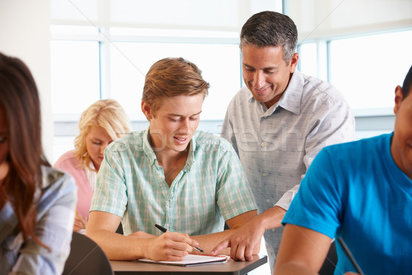 Tutor helping student in class Stock photo © monkey_business